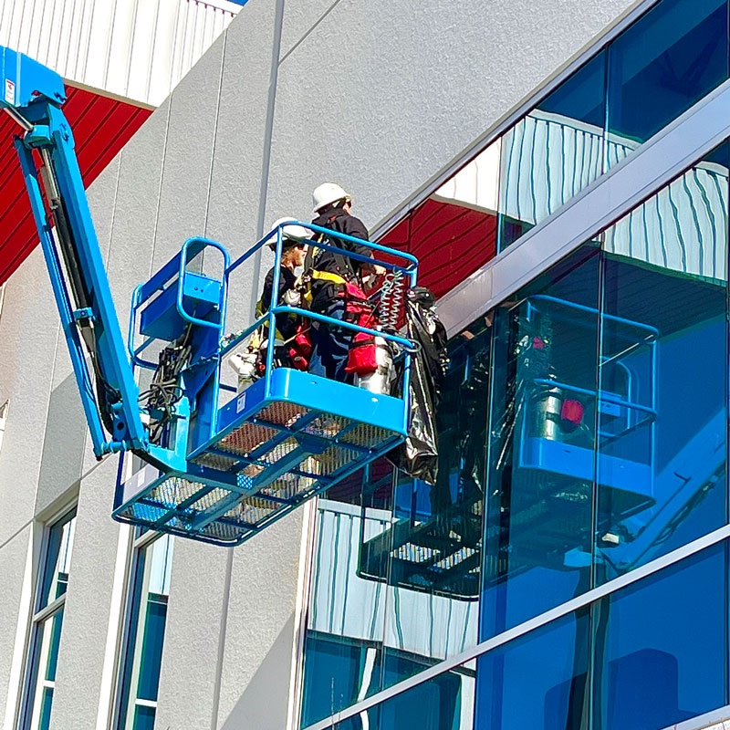 cherry picker with guys cleaning window